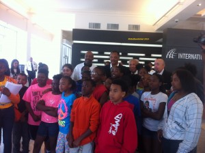 Reverend Jackson spoke with a group of students while the press encouraged a group photo.